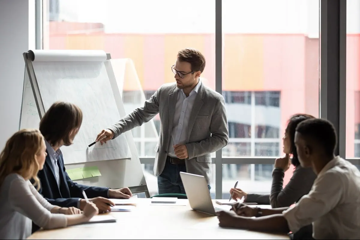 Hands record decisions on a structured planning document.